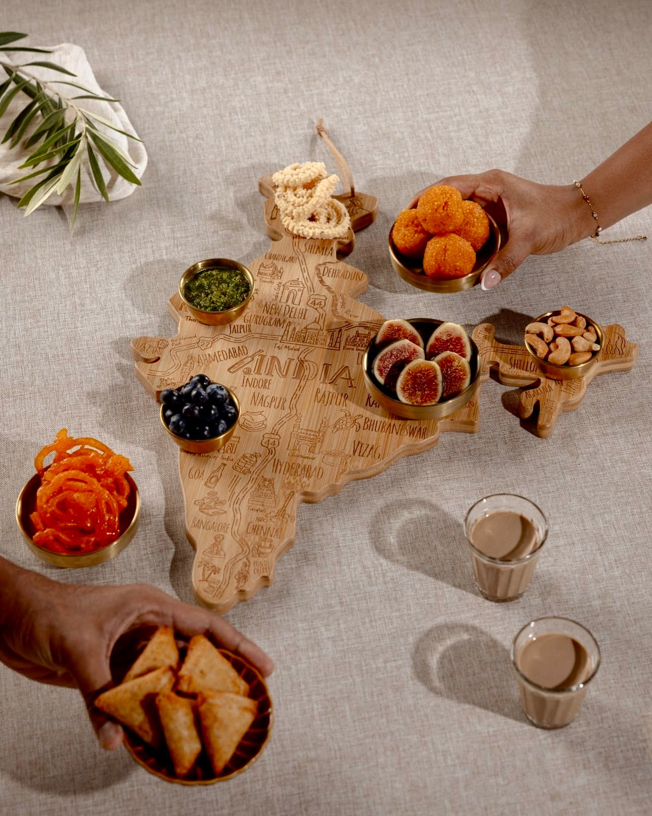The India Board styled with chai, fruit, sweets, and Indian snacks for a shared table